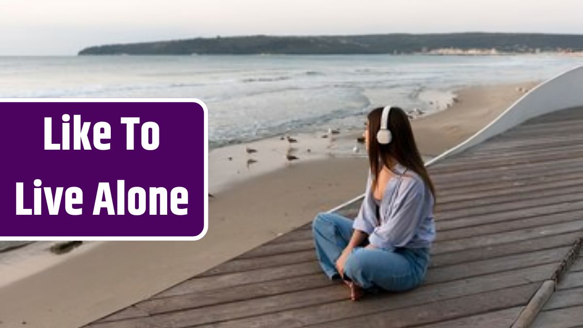 Side view woman listening to music next to the sea