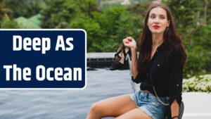 Young stylish hipster woman, sitting at pool, tropical vacation, carefree, natural beauty, holding shoes in her hands, red lips