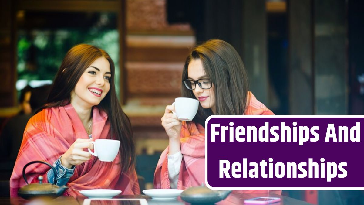 Two young and beautiful girls gossiping on the terrace with a cup of coffee