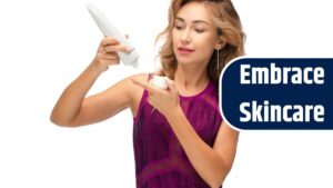 Studio stock photo of a gorgeous young adult woman in her 30s dropping lifting cream from the bottle onto her finger. Testing new anti-age product. Beauty and skincare concept. Isolate on white.