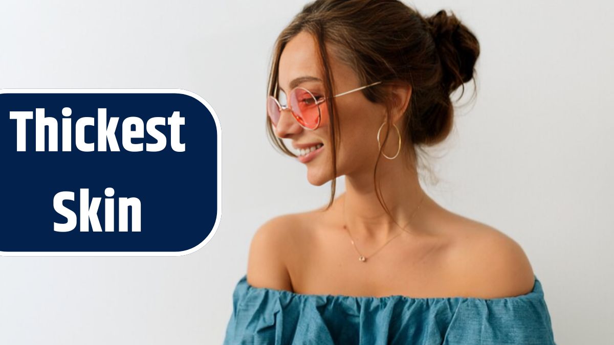 Close up portrait of smiling tenderness woman with lovely smile wearing round pink glasses and denim top with bare shoulders posing over isolated background