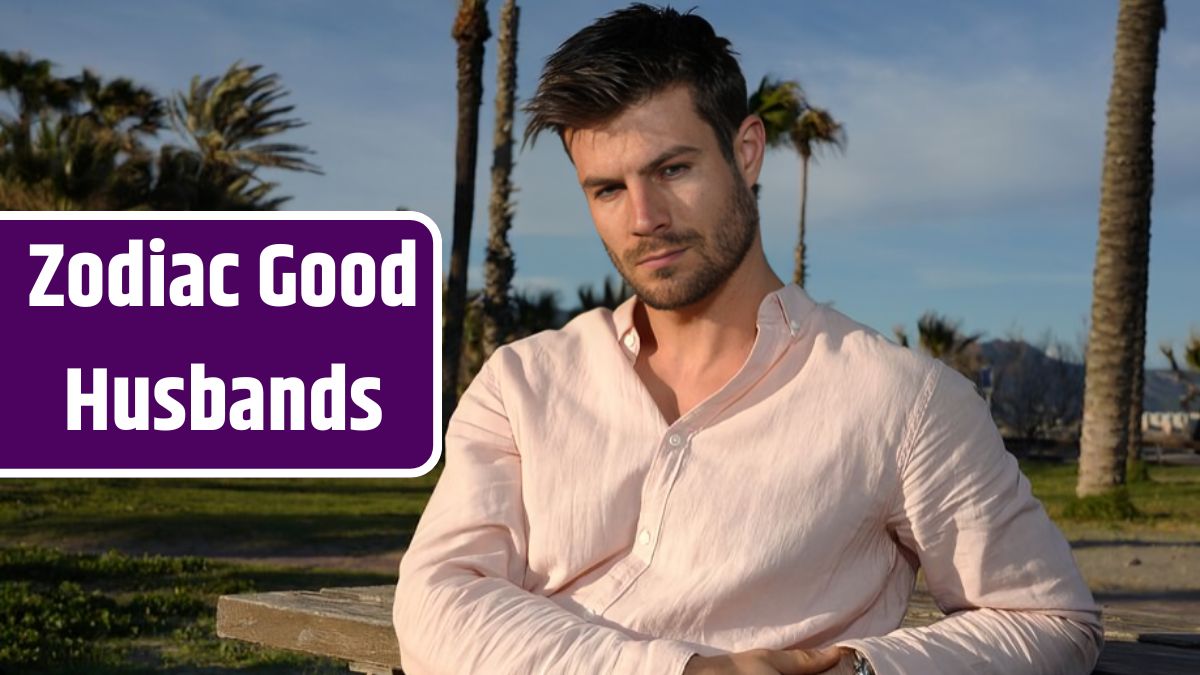 Young Hispanic male wearing a pink shirt and posing on the beach near palm trees