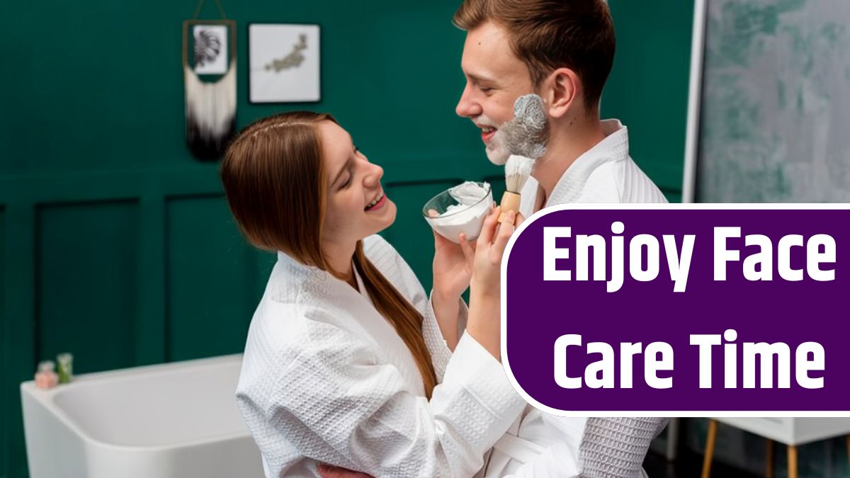 Embraced couple in bathrobes applying shaving foam