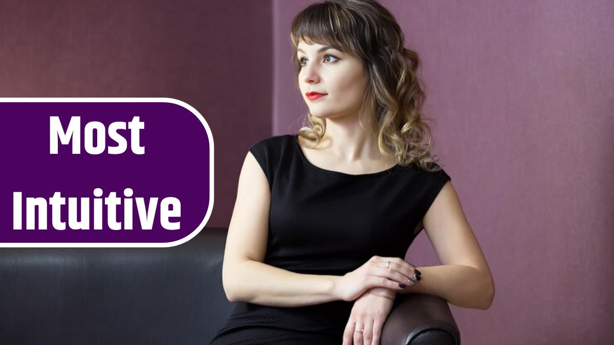 Beautiful woman sitting on sofa against wall