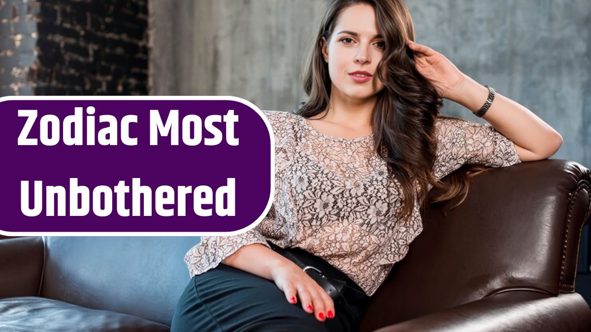 An attractive young woman sitting on sofa looking at camera