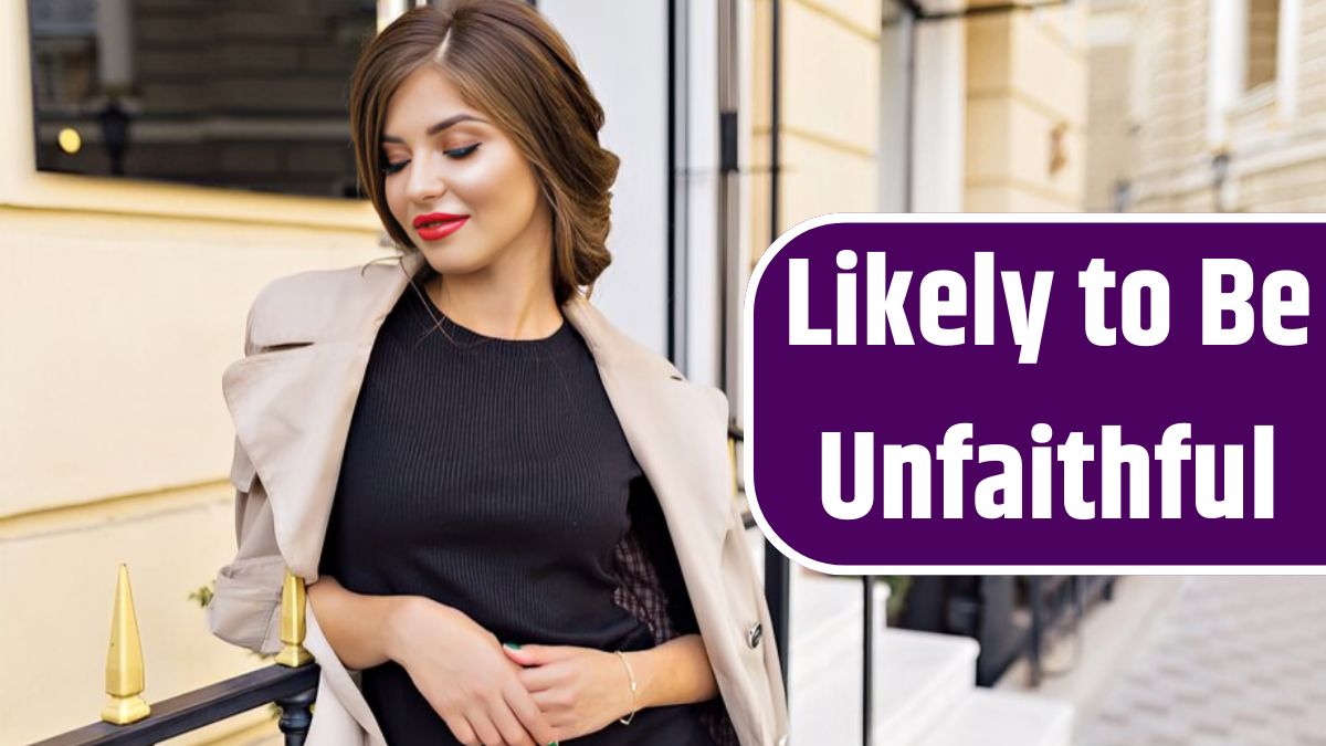 Pretty woman dressed in black dress and beige trench with stylish hairstyle and red lips at the street